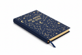 Celestial Slim Ruled Journal – studio shot showing gold foil cover stamping and silk ribbon bookmark emerging from gilt-edged page block